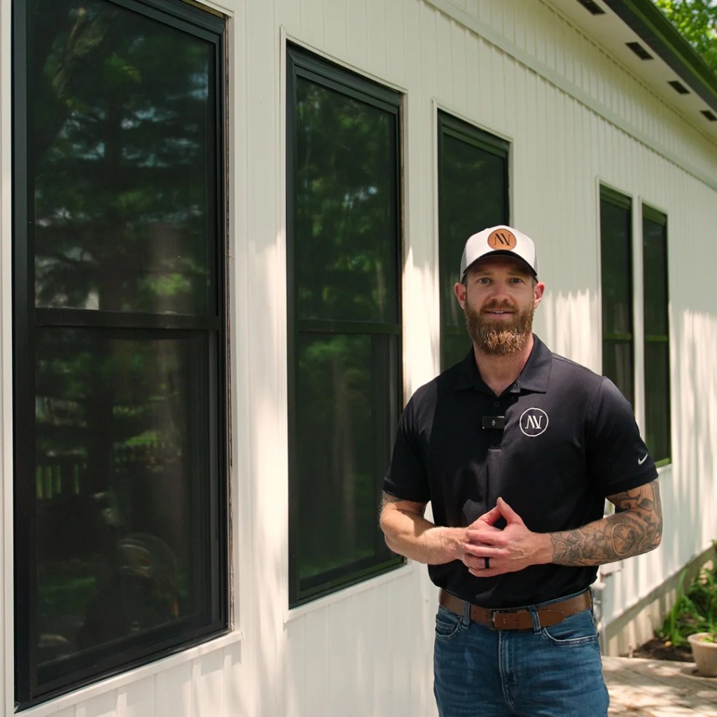 Nathan Owner of Virtual View Windows Standing besides of a window
